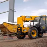 JCB 506-36 Telescopic Handler moving materials on dirt path.