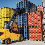 JCB 66-40E electric teletruk stacking pallets outdoors.