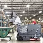 Advance CS7010 sweeper/scrubber dumping dust and debris into garbage.
