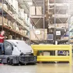 Advance CS7010 sweeper/scrubber cleaning warehouse shop floor.