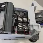 Advance SW4000 rider sweeper's seat lifted up, showing battery compartment.
