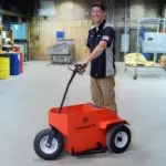 Operator driving Columbia Chariot through shop.