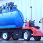 red Columbia Custom Platform utility vehicle with large tank feature added on the trucks bed.