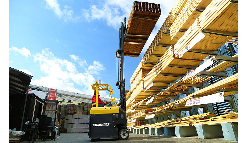Combilift COMBI-CB Forklift lifting lumber in outdoor lumber yard.