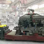 Combilift Combi-PPT 3,000 kg to 16,000 kg pedestrian stacker carrying large manufacturing materials.