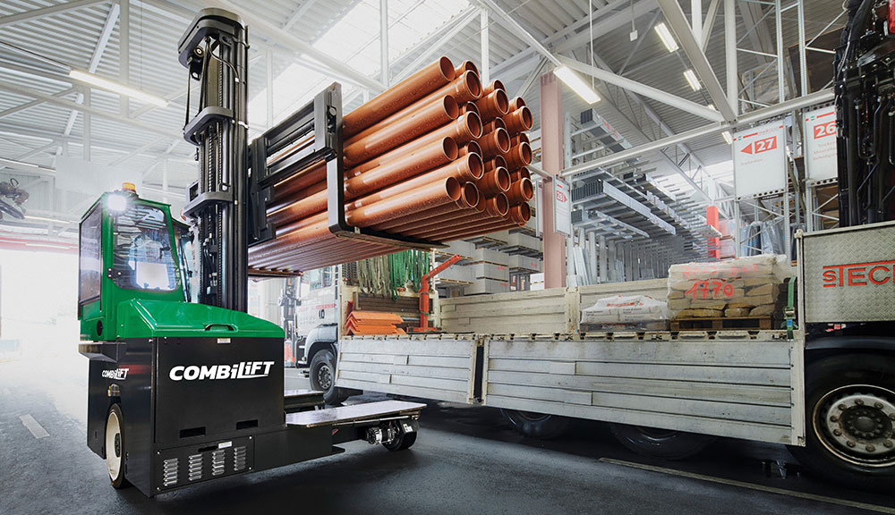 Combilift C Series C6000E electric forklift carrying materials in warehouse.