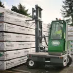 Combilift C10000-4WSL Side Loader Narrow Aisle forklift getting material outdoors.