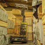 Combilift C12000-4WSL Two Directional Sideloader Forklift in lumber warehouse.