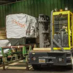 Combilift C12000-4WSL Two Directional Sideloader Forklift in action side view.