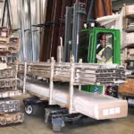 Combilift C Series C6000E electric forklift carrying materials in warehouse.