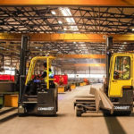 Combilift COMBI-CB Forklifts carrying supplies in heavy manufacturing and fabrication industry.