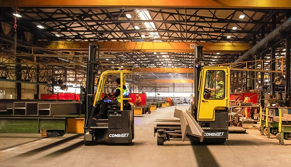 Combilift COMBI-CB Forklifts carrying supplies in heavy manufacturing and fabrication industry.