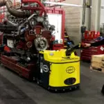 Combilift Combi-PPT 3,000 kg to 16,000 kg pedestrian stacker in automotive manufacturing industry warehouse.