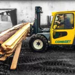 Combilift Combi-RT Rough Terrain Forklift transporting lumber outdoors.
