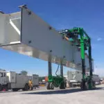 Combilift COMBI-SC3 Special Applications Straddle Carrier carrying a large block of Steel.