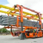 Combilift Combi-SC telescopic chain straddle carrier carrying steel blocks in Steel Fabrication industry.