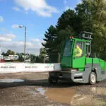 Combilift SL12000 forklift truck transporting materials outdoors.