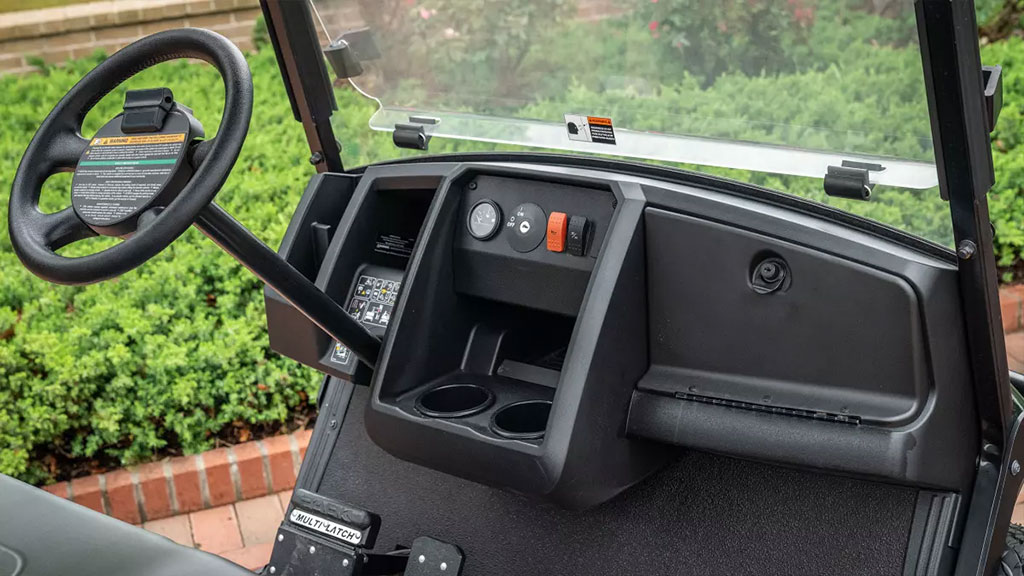 Cushman Shuttle 2+2 personnel carrier functional dash area with steering wheel, controls and cupholders.