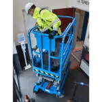operator looking over bucket gate in Genie GS-1432m scissor lift.