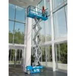 Genie GS-1930 aerial scissor lift with operator raised in bucket cleaning glass windows.