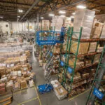 Genie GS-1930 slab scissor lift raised inside warehouse.