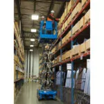 Genie GS-4046 scissor lift with worker raised in bucket.