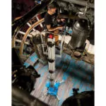 Worker repairing lighting fixtures and wires on Genie AWP-25S Aerial Work Platform.