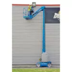 Genie GR-27J vertical mast lift raising worker to top of building.