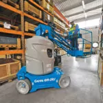 Genie GR-27J vertical mast lift in warehouse area.