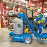 Genie GR-27J vertical mast lift in manufacturing warehouse.