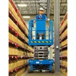 Worker transporting through warehouse aisles in Genie GS-4046 scissor lift.