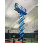 Genie GS-4069 DC scissor lift raising operators to ceiling.