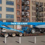 Genie SX-135 XC telescopic boom lift on a trailer.