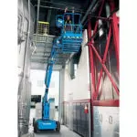 Genie Z-34/22 boom lift raising operator to repair pipe along the ceiling.