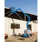 Genie Z-34/22 boom lift raising repairman to building roof.