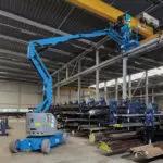 Z-34/22 boom lift raising operator to work shop ceiling.