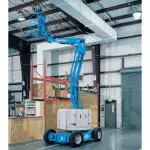 Genie Z-34/22 boom lift raising electrician to ceiling.