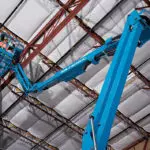 Genie Z-40/23 N articulating boom lift raising operator to ceiling.