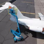 Genie Z-45/25J DC boom lift repairing airplane tail.