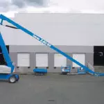 Genie Z-80/60 articulated boom lift being lowered.
