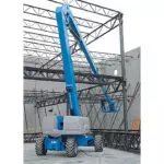 Genie Z-80/60 slightly raising operator to building structure.