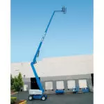 Genie Z-80/60 articulating boom lift extended with operator.