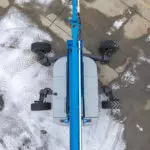 top of Genie ZX-135/70 articulating boom lift with wheels turned.