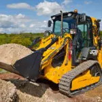 JCB 1CXT Backhoe Loader carrying dirt.
