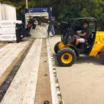 JCB 504-13 Telehandler moving pallet of materials.
