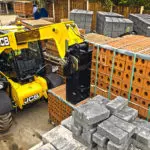 JCB 505-20TC Telehandler lifting large bricks.