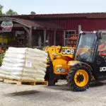 JCB 505-20TC Telehandler carrying pallet with materials.