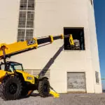 JCB 514-56 Telescopic Handler lifting materials into building.