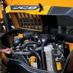 JCB 514-56 Telescopic Handler engine area and operator.
