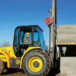JCB 930 Rough Terrain Forklift carrying concrete bricks.